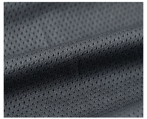 Detailed macro view of dark grey honeycomb mesh fabric with high breathability features