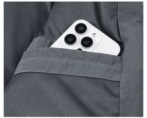 Macro shot of men's sports jacket inner mesh pocket with phone for size reference
