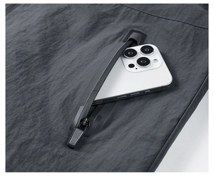 Close-up of waterproof zipper pocket on men's jacket holding a smartphone securely