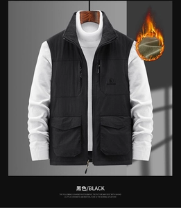 Close-up of black outdoor vest featuring multi-pocket design and stand collar detail
