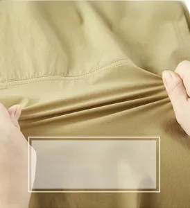 Macro shot of khaki work shirt fabric showing durable texture and wrinkle-resistant stretch