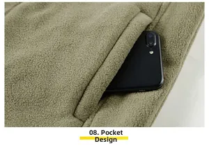 Detail view of large side pocket on military green fleece vest with mobile phone