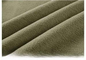 Macro view of army green polar fleece fabric texture showing soft thick warm material