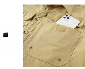 Detail of khaki outdoor shirt featuring a secure chest pocket with a velcro closure and reinforced seams