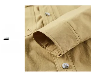 Close-up of khaki casual shirt cuffs showing fine stitching and grey four-hole buttons