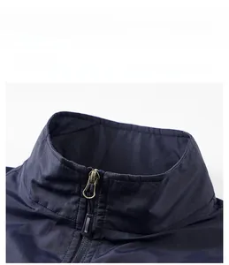 Close-up of stand-up collar and metallic zipper on navy blue lightweight outdoor vest