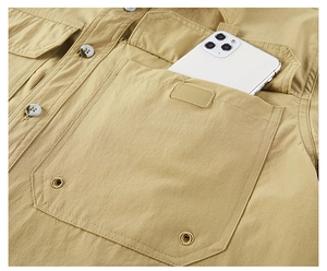 Detail of khaki tactical shirt cargo pocket with velcro closure and ventilation eyelets