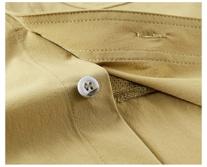 Close-up of khaki breathable shirt featuring reinforced stitching and marble texture button