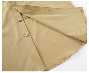 Detail of khaki tactical shirt showing breathable mesh lining and durable fabric texture