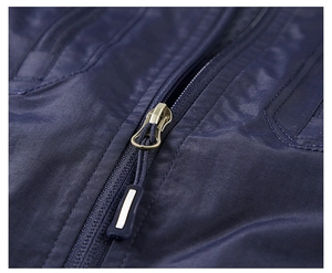 Detailed close-up of premium metal zipper and durable navy blue outdoor vest fabric