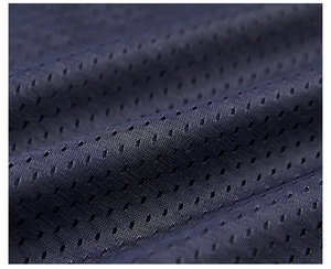 Macro shot of deep blue mesh fabric showing breathable holes for multi-functional vest