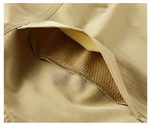 Close-up of khaki utility shirt pocket showing breathable mesh lining and durable fabric