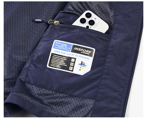 Detail view of mesh lining and interior zipper pocket on navy blue outdoor vest
