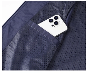 Detail view of the breathable mesh lining and large interior pocket with a smartphone