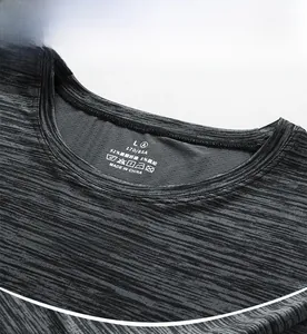 Detail view of round neckline with heat-transfer label and gray breathable fabric texture