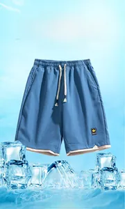 Detail of light blue quick-dry shorts with elastic drawstring waist and mesh texture