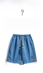 Detail of navy casual shorts featuring adjustable drawstring waist and white layered hem