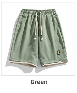 Detail of green quick-dry shorts featuring an elastic drawstring waist and layered hem design