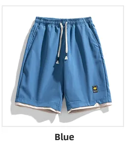 Detail of blue quick-dry shorts featuring elastic drawstring waist and maple leaf patch