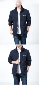 Detail view of navy fleece jacket featuring outdoor embroidery and high-neck zipper