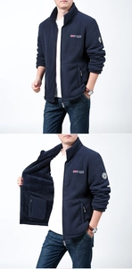 Detail showing deep blue fleece jacket with stand-up collar and outdoor embroidery