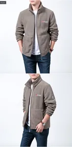 Detail view of khaki fleece jacket featuring high collar zip and outdoor embroidery