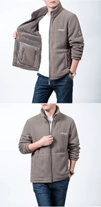 Detail view of khaki polar fleece jacket showing embroidery logo and vertical stand-up collar