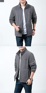 Detail view of grey polar fleece jacket with embroidered outdoor logo and side pockets