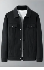 Detail view of black men jacket showing wool texture lapel collar and flap chest pockets