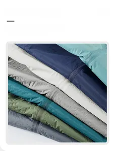 Close-up of lightweight sun protection jackets in seven colors with textured fabric and zippers