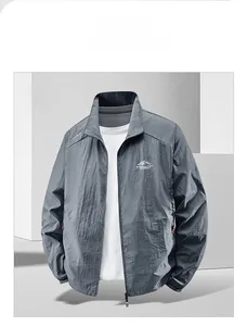 Detail of dark gray men's sun protection jacket with zip-up collar and logo