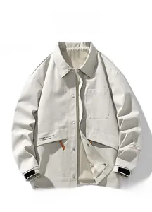 Detail of khaki men's jacket featuring large chest pocket and adjustable velcro cuffs