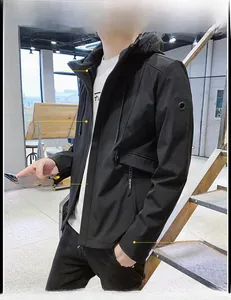 Detail of slim-fit men's hooded jacket with 3D tailoring and high-collar windproof design