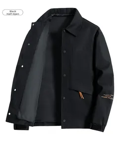 Detail of black business casual jacket featuring snap buttons and orange text on sleeve
