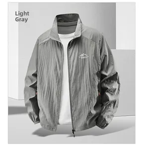 Close-up of light gray sun protection jacket with outdoor prints and elastic cuffs