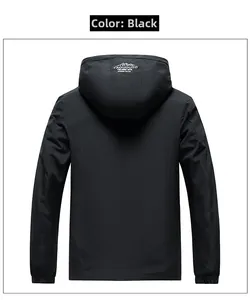 Detail of black waterproof jacket back featuring a mountain logo on the detachable hood