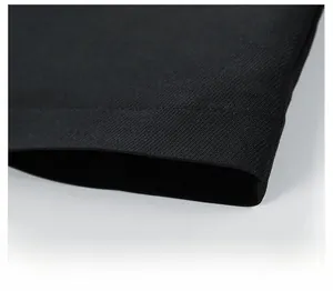Detailed macro view of the straight hem design and twill texture on a black business jacket