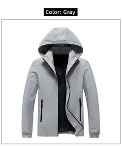 Detail of grey hooded jacket showing waterproof zipper pockets and mountain logo
