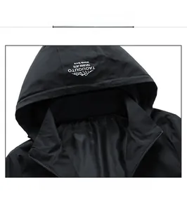 Close-up of a men's waterproof hooded jacket with white graphic print on a black hood