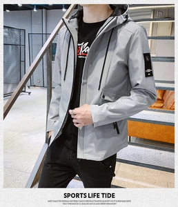 Detail of light gray windbreaker showing drawstring hood and chest lettering print