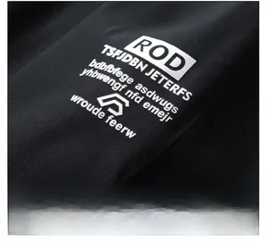 Detail of arm sleeve with high-density 3D rubberized printing on black jacket fabric