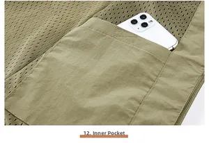 Detail view of the inner mesh pocket on a green fishing vest showing its large storage capacity