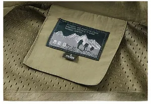 Macro detail of breathable mesh lining and size label on military green outdoor vest