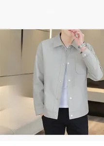 Detail of light grey men's jacket with honeycomb textured fabric and a chest pocket