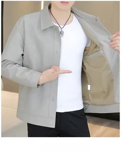 Detail view of light gray jacket featuring vertical texture, snap buttons and inner pocket