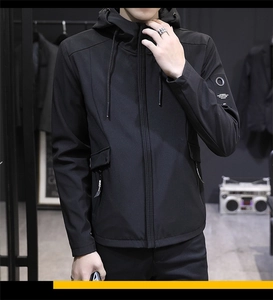 Detail of men's black hooded jacket featuring a sleeve print and windproof fabric texture