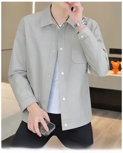 Detailed view of light gray shirt jacket showing fine texture and silver snap buttons