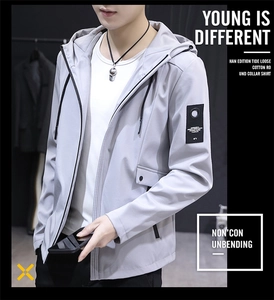 Detail of light grey men's hooded jacket featuring drawstring hood and sleeve patch