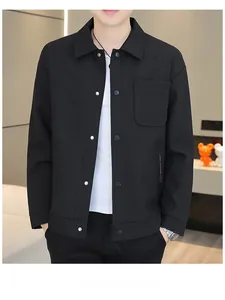 Detailed close-up of a black shirt jacket with silver metal snap buttons and chest pocket
