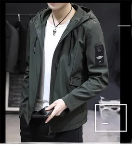 Detail of army green hooded jacket showing drawstring hood and sleeve patch